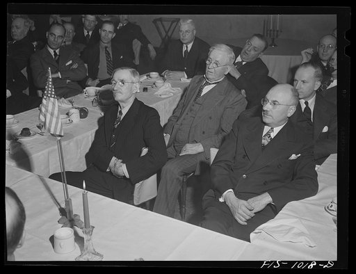 Minneapolis, Minnesota. On the left, former state senator Swanson and on the right Mr. H.E. Brandt, listening to Mr. Peterson's speech