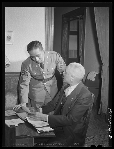 Untitled photo, possibly related to: Baltimore, Maryland. Sargeant Franklin Williams, home on leave from Army duty, discussing insurance problems with his father