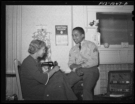 Untitled photo, possibly related to: Baltimore, Maryland. Sargeant Franklin Williams, home on leave from Army duty, watching his mother sew a button on his uniform