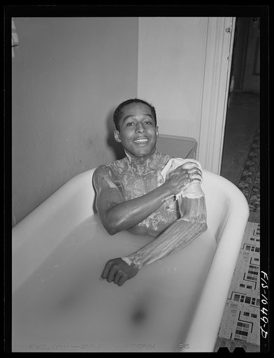 Untitled photo, possibly related to: Baltimore, Maryland. Sargeant Franklin Williams, home on leave from Army duty, taking a bath