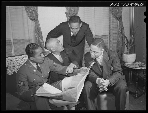 Untitled photo, possibly related to: Baltimore, Maryland. Sargenat Franklin Williams, home on leave from Army duty, with his father, brother, and brother-in-law discussing the news after dinner