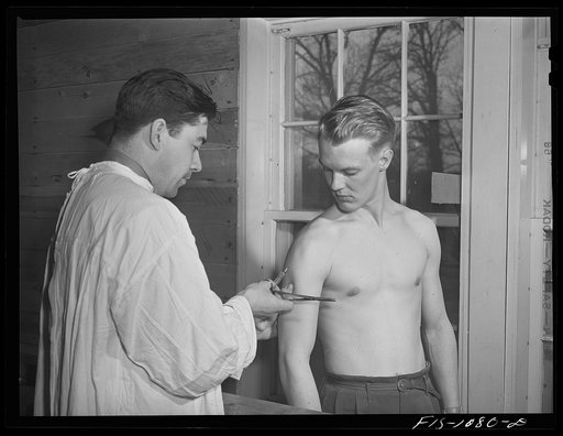Swedish-American selectee receiving an injection as he is inducted into the U.S. Army