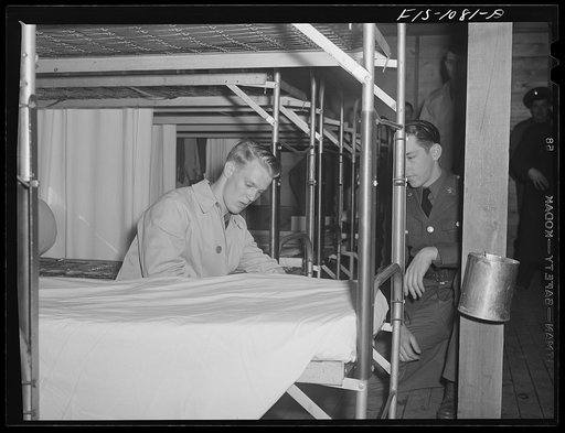 Swedish-American selectee in Minnesota learning how to make a bed as he is inducted into the U.S. Army