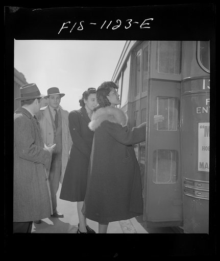 Washington, D.C. Jewal Mazique [i.e. Jewel], worker at the Library of Congress, buying a paper on her way home