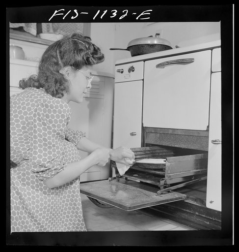 Untitled photo, possibly related to: Washington, D.C. Jewal Mazique [i.e. Jewel] cooking dinner after a hard day's work in the Library of Congress