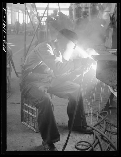 A defense worker who was born in Sweden, welding at a plant in Minnesota, possibly the Northern Pump Company in Minneapolis