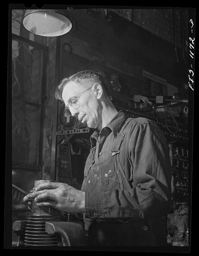 A defense worker who was born in Sweden welding at a plant in Minnesota, possibly the Northern Pump Company in Minneapolis
