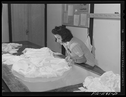 Laying out pilot parachute on the inspection table at the Pacific Parachute Company, San Diego, California