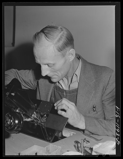 Repairman for the sewing machines at the Pacific Parachute Company. San Diego, California