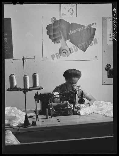 Untitled photo, possibly related to: Hemming a pilot parachute on a double needle sewing machine at the Pacific Parachute Company. San Diego, California