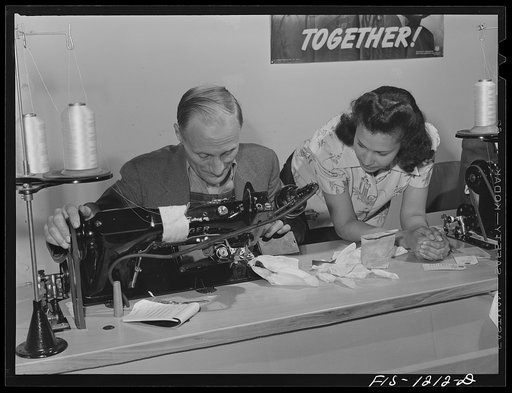 Repairman working on a sewing machine at the Pacific Parachute Company. San Diego, California