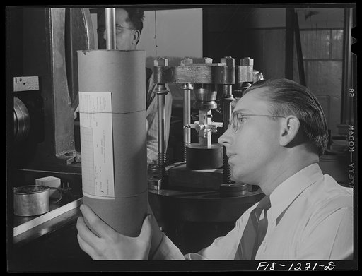 Forest Products Laboratory, Madison, Wisconsin. Testing a block of wood to show the effect of compression parallel to the grain. As pressure is applied to the block, a lamb's roller extensometer is used to plot the effect on a graph