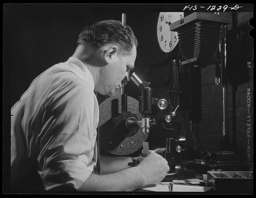 Untitled photo, possibly related to: Forest Products Laboratory, Madison, Wissonsin. Dr. R.O. Marts in his laboratory. He is using an Ultropak microscope for the detection of obscure defects in airplane veneer