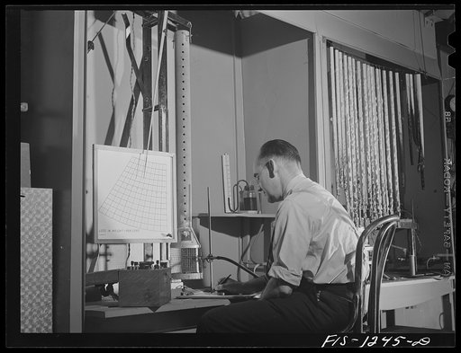 Forest Products Laboratory, Madison, Wisconsin. Testing the fire-resistant qualities of various types of wood impregnations and coatings by the use of the firetube. Mr. Arthur Van Kleek, in charge of the work, is taking the readings