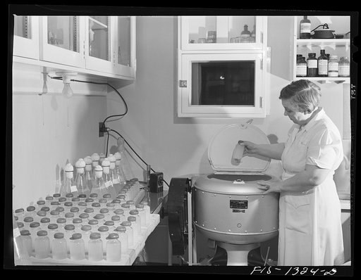 Placing typhus vaccine in centrifuging machine. USPHS (United States Public Health Service)  Rocky Mountain Laboratory. Hamilton, Montana