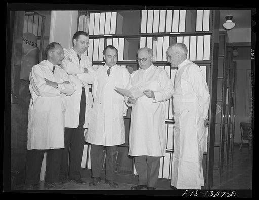 Dr. Davis, Dr. Steinhaus, Dr_____, Dr. Parker (director), and Dr. Cooley, in library of the USPHS (United States Public Health Service)  Rocky Mountain Laboratory at Hamilton, Montana