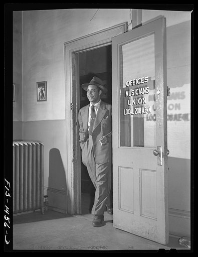 Oliver Coleman, drummer, making one of his biweekly visits to his union hall, local 208 of the Musicians' Union. He is proud of his union and of the musicians' hall. His local is one of the largest in the country and are all Negroes. Chicago, Illinois