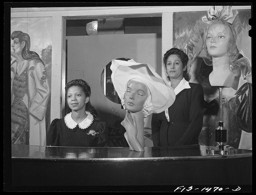 Miss Minnie Coleman (left), clerk, and Miss Selma Barbour (right), manager of the Cecilian Specialty Hat Shop. 454 East 47th Street, Chicago, Illinois