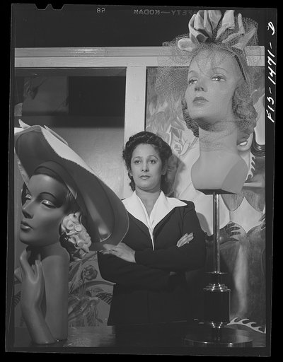 Miss Selma Barbour, manager of the Cecilian Specialty Hat Shop, 454 East 47th Street. Miss Barbour has been managing this store for one year, and has been in business for four years. She was born in New Orleans, and has eight brothers, seven of whom are eligible for the Army. Chicago, Illinois