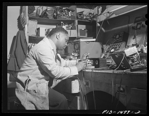 Mr. Thomas Dorsey, radio technician, in Green's radio and electrical store. Mr. Dorsey is an expert radio repairman and studied at the Tilden technical school in Chicago, Illinois