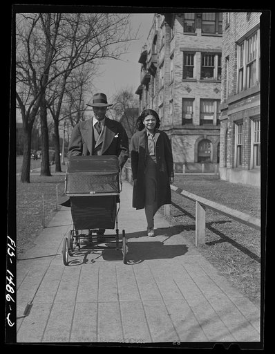 Mr. and Mrs. Oliver Coleman taking their five-month-old son out for some air along Indiana Avenue. Chicago, Illinois