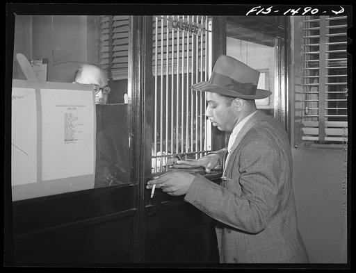Oliver Coleman, drummer, paying his dues at Musicians' Hall, the headquarters of local 208 of the musicians' union. Chicago, Illinois