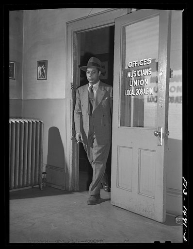 Untitled photo, possibly related to: Oliver Coleman, drummer, making one of his biweekly visits to his union hall, local 208 of the Musicians' Union. He is proud of his union and of the musicians' hall. His local is one of the largest in the country and are all Negroes. Chicago, Illinois