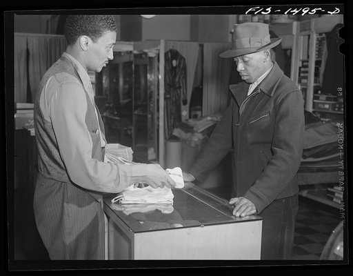 Mr. William Strong (left), manager of the Henry C. Taylor Store for Men, selling underclothes to Mr. J. Foster. 47th Street near State Street, Chicago, Illinois