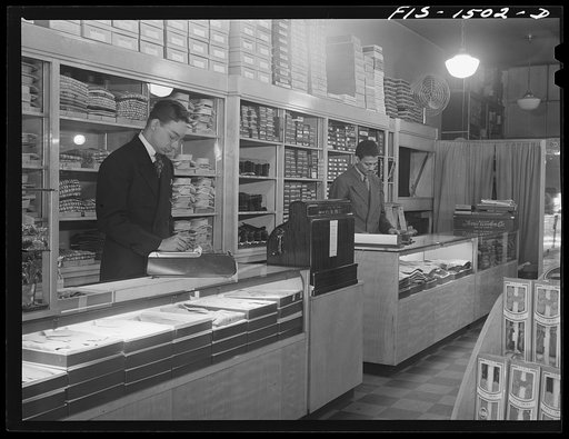 Untitled photo, possibly related to: Mr. William Strong (left), manager of the Henry C. Taylor Store for Men, selling underclothes to Mr. J. Foster. 47th Street near State Street, Chicago, Illinois