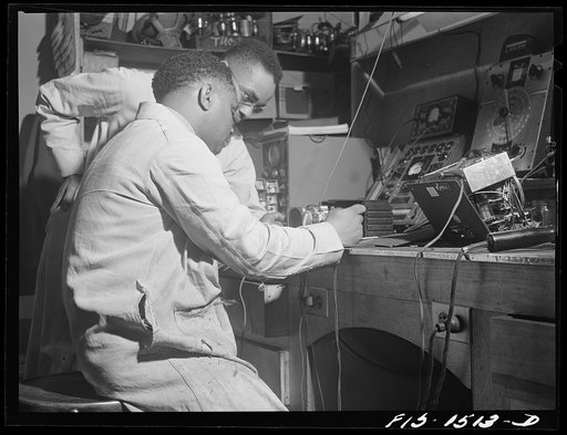 Untitled photo, possibly related to: Mr. Thomas Dorsey, radio technician, in Green's radio and electrical store. Mr. Dorsey is an expert radio repairman and studied at the Tilden technical school in Chicago, Illinois