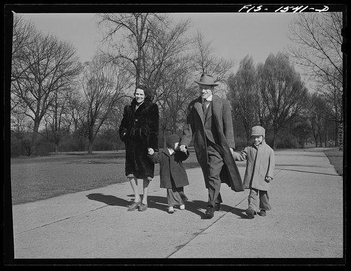 Untitled photo, possibly related to: Mr. and Mrs. "Red" Sounders [i.e. Saunders] and the children go for a walk in the park on a brisk April Sunday afternoon. Chicago, Illinois