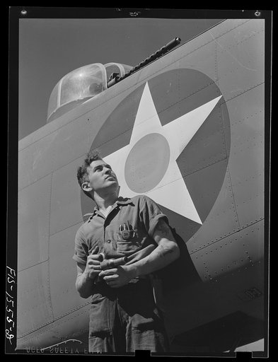 North American Aviation Incorporated. Inglewood, California(?). A worker with a rivet gun is shown admiring a North American B-25 medium bomber