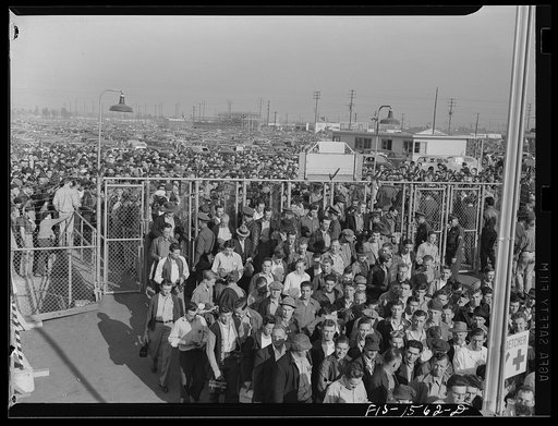 Untitled photo, possibly related to: North American Aviation, Incorporated, Inglewood, California. Thousands of skilled craftsmen all over America enter the gates of warplane factories each day. Employees must display their badges and identification cards before admittance