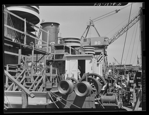 California Shipbuilding Corporation, Wilmington, California. Cargo winches and superstructure on the deck of a Liberty ship in the final stages of construction