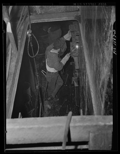 California Shipbuilding Corporation, Wilmington, California. Welder working on the hull of a Liberty ship