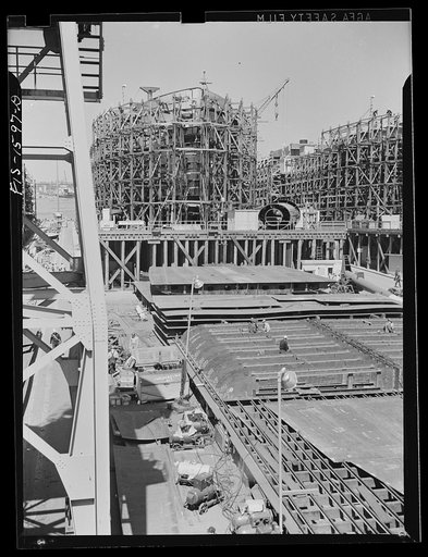 California Shipbuilding Corporation, Wilmington, California. Prefabricating table in front of partially-completed ships on the ways