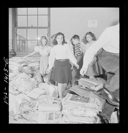Untitled photo, possibly related to: Washington, D.C. Scrap salvage campaign, Victory Program. Schoolchildren bring their scrap paper from their classrooms into the cellar, where it is picked up by paper company truck