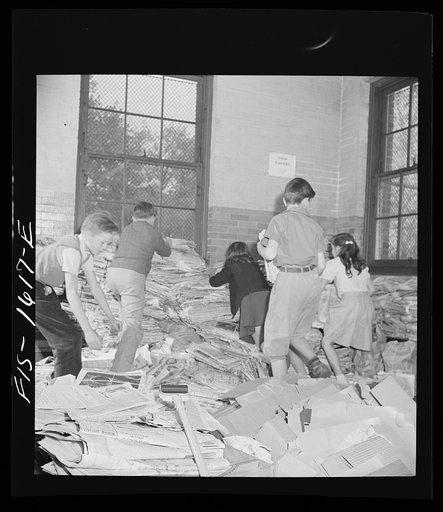 Untitled photo, possibly related to: Washington, D.C. Scrap salvage campaign, Victory Program. Schoolchildren bring their scrap paper from their classrooms into the cellar, where it is picked up by paper company truck