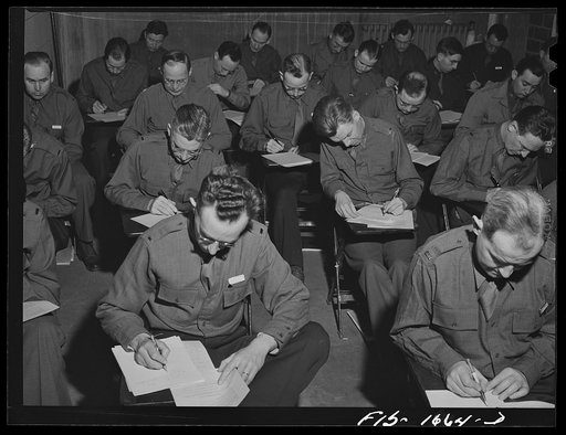 Taking an examination in graves registration at the chaplain school. Fort Benjamin Harrison, Indiana