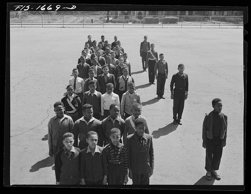 School children at a grammar school in Indianapolis listening to a speech by Chaplain George Washington Williams, who is just graduating from the U.S. Army chaplain school. Fort Benjamin Harrison, Indiana