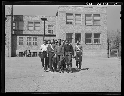 Negro schoolchildren of the Military Officers' Training Corps marching in formation for Chaplain George W. Williams, a graduate of the U.S. Army chaplain school at Fort Benjamin Harrison, Indiana. The MOTC was organized at the school by the teachers for those youngsters who wanted some preparation f