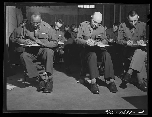 Taking an examination in graves registration at the U.S. Army chaplain school. Fort Benjamin Harrison, Indiana