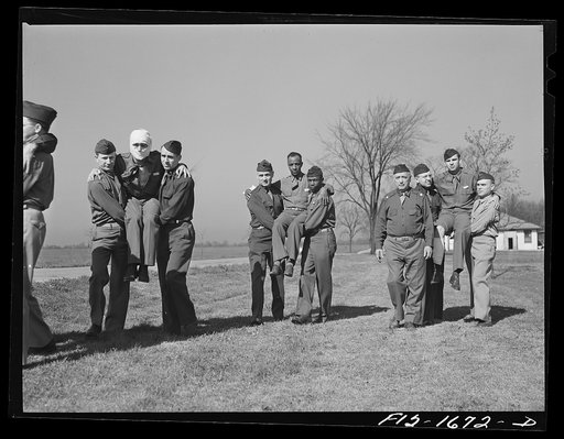 A first aid class at the chaplain school, learning the proper methods of carrying the wounded. U.S. Army chaplain school, Fort Benjamin Harrison, Indiana