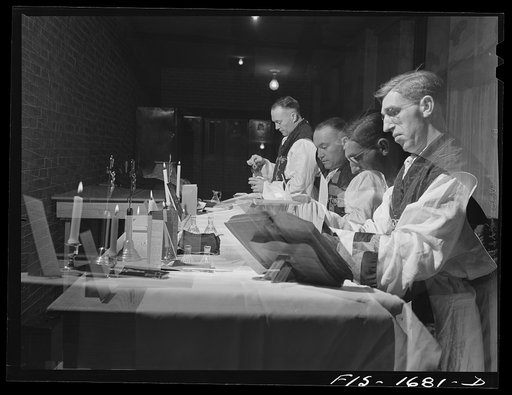 Untitled photo, possibly related to: Chaplain Joseph W. Duane of Albany, New York and Chaplain Fredric Thissen of Minnesota, Catholics, saying mass at the U.S. Army chaplain school. Fort Benjamin Harrison, Indiana