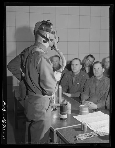 Untitled photo, possibly related to: Captain William W. Kitchen instructing chaplain school class in gas warfare and the use of gas masks. U.S. Army chaplain school, Fort Benjamin Harrison, Indiana
