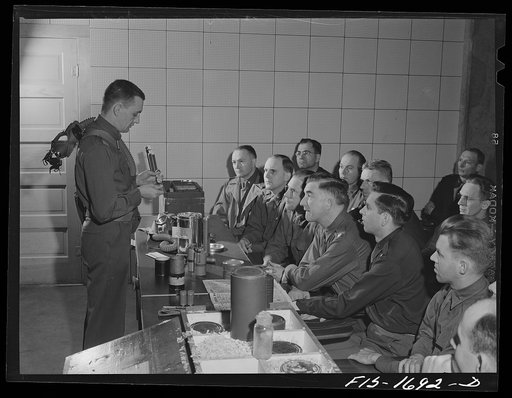 Captain William W. Kitchen instructing a Chaplain School class in gas warfare and the use of gas masks. U.S. Army chaplain school, Fort Benjamin Harrison, Indiana