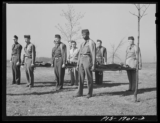 Chaplains being instructed in the proper use of stretchers during a first aid class at the U.S. Army chaplain school. Fort Benjamin Harrison, Indiana