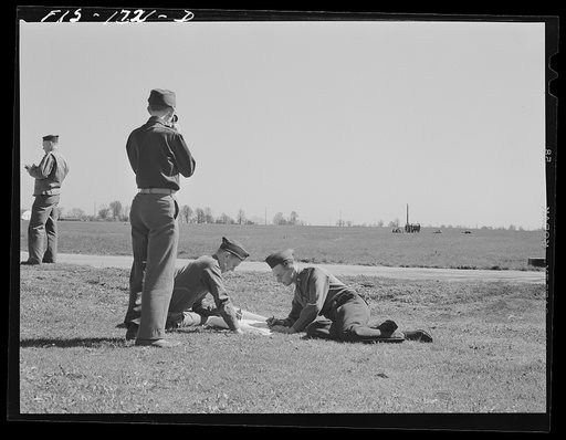 Students at the U.S. Army chaplain school, Fort Benjamin Harrison, Indiana, studying map reading, which will be useful to them in locating and marking graves of soldiers who die on the battlefield