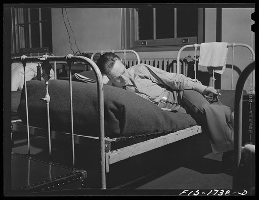 Chaplain E.R. Taft, Episcopal, of Bridgeport, Connecticut studying for examinations in his bunk at the U.S. Army chaplain school. Fort Benjamin Harrison, Indiana