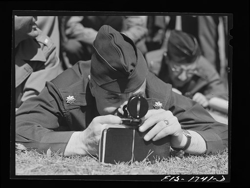 Chaplain P.M. Hickcox, Methodist, learning to sight distances in a map reading class at the U.S. Army chaplain school. Fort Benjamin Harrison, Indiana